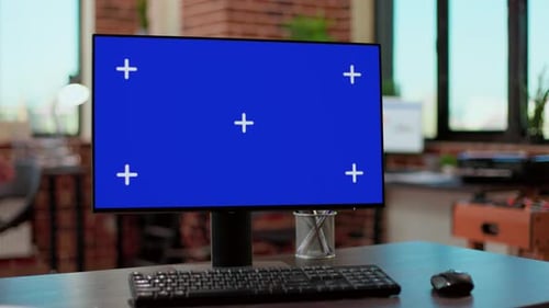Computer with Blue Screen in Modern Office Setting