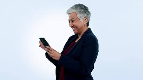 Happy, laugh and senior business woman with phone in studio for funny, text