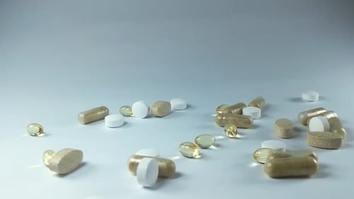 Variety of Pills on a White Surface