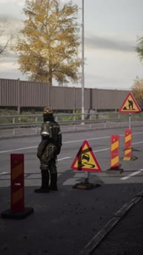 Road Worker Managing Traffic in a Construction Zone During Late Afternoon
