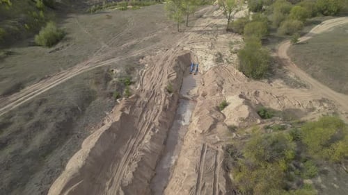 Trench Made with Precision Traverses Forest Ready to House Pipelines