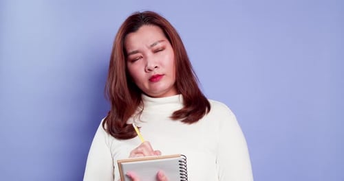 Young Woman Writing Notes in a Studio