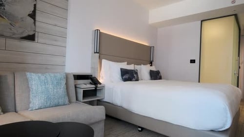 Modern Hotel Room with Comfortable Bed and Sofa