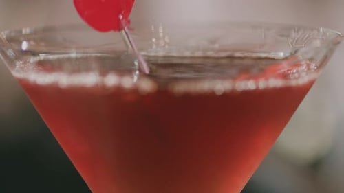Close-up of a Martini Glass with a Metal Toothpick and Cherry.