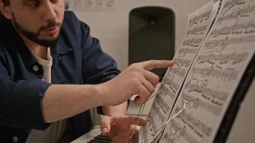 Music Teacher Explaining Sheet Music to Girl during Lesson