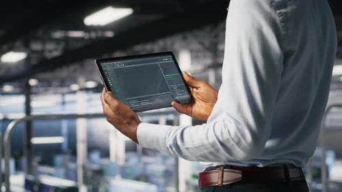 Close Up of Data Center Programmer Looking at Code Debugging Tools on Tablet