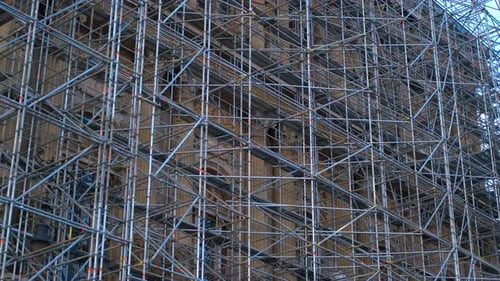 Complex Scaffolding Structure Surrounding a Tall Building Under Renovation