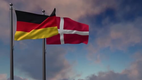 Germany and Denmark Flags Waving Against a Cloudy Sky