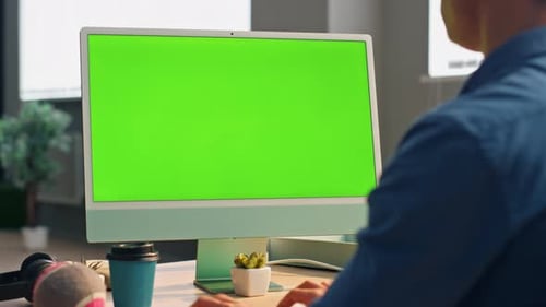 Unknown businessman texting chromakey computer keyboard at modern office workplace