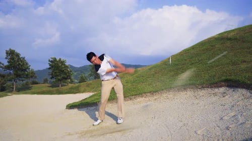 Professional Male Golfing walking with club on golf course