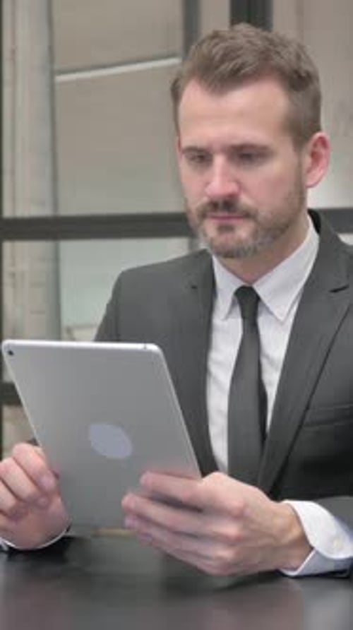 Man in Suit Using Tablet at Work