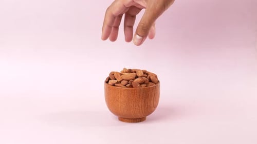 Side View of Hand Pick Almond Nuts
