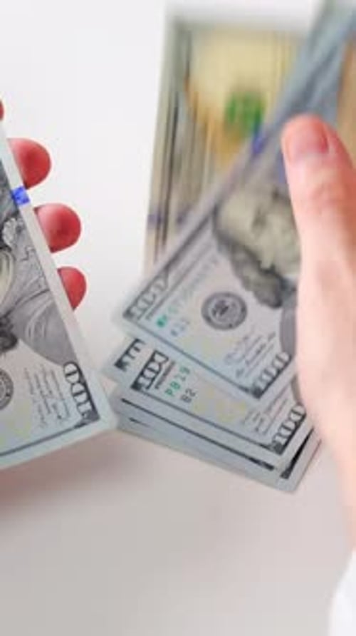 Counting Stack of United States Currency