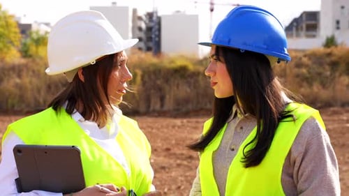 Female architect and engineer working on a construction site