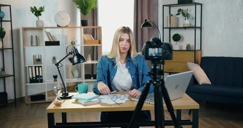 Young Woman Filming Vlog At Desk