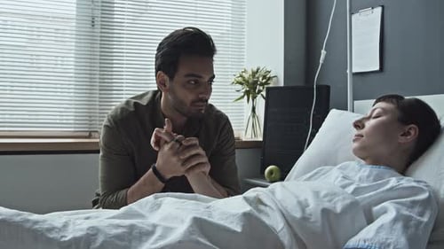 Man Holding Hand of His Girlfriend in Coma