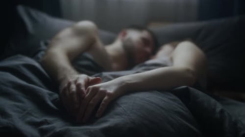 Couple Sleeping Together in Bed at Home