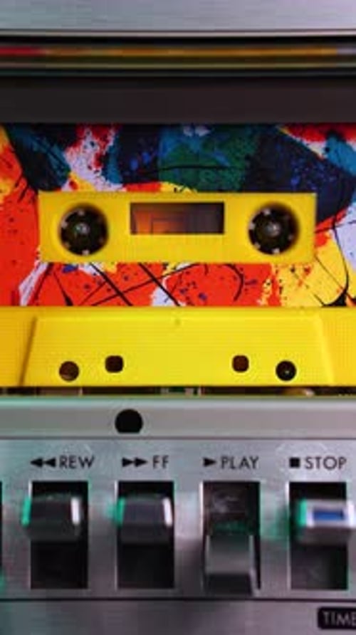 Vertical: Audio Cassette Tape With Colorful Sticker Playback, Close Up