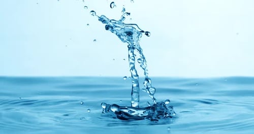 Drop of water falls into a drop of water in a super slow motion. Shot on super slow motion 1600 fps.