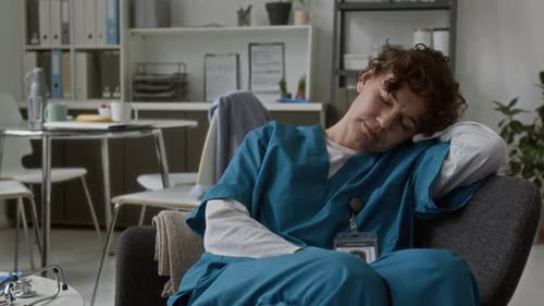 Health Worker Sleeping in Medical Office Setting