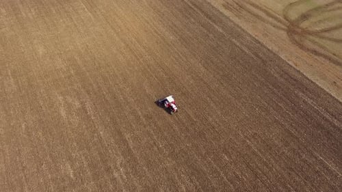 Spring Agricultural Field Work, Tractor With Seeder Sow Seeds in Ground Aerial Slow Motion