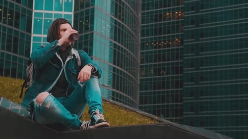 Young Adult Drinking Coffee in Urban City Setting