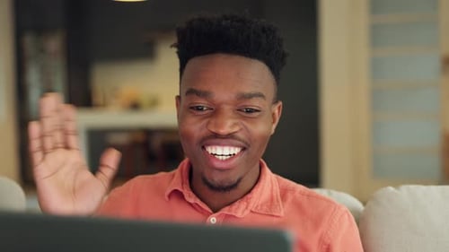 Man Smiling and Waving on a Video Call