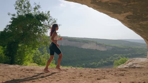 Athletic Woman Runs Against Stunning Mountain Landscape During Sunset
