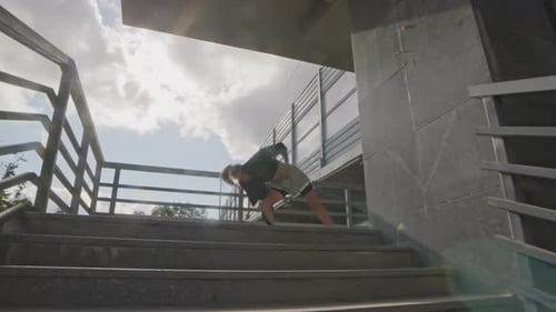 Young Adult Performs Acrobatic Back Handspring on Stairs
