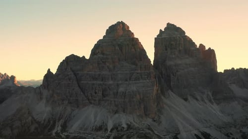 As the Sun Ascends the Mountainous Landscape Unveils the Grandeur of the Majestic Three Peaks of