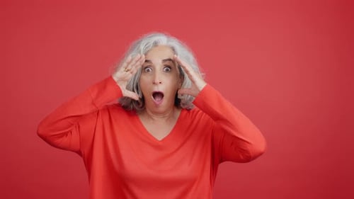 Shocked Woman Reacts with Hands to Face