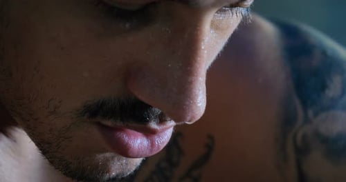 A professional boxer, thinks about fighting, in a good body, elastic bandages, punches bag. Concep