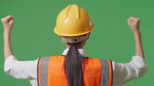 Close Up Back View Of A Female Engineer Raising Her Hands Celebrating In The Green Screen
