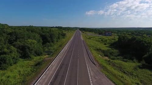 Aerial View Above Cars Driving Along Empty Countryside Road on Sunny Day