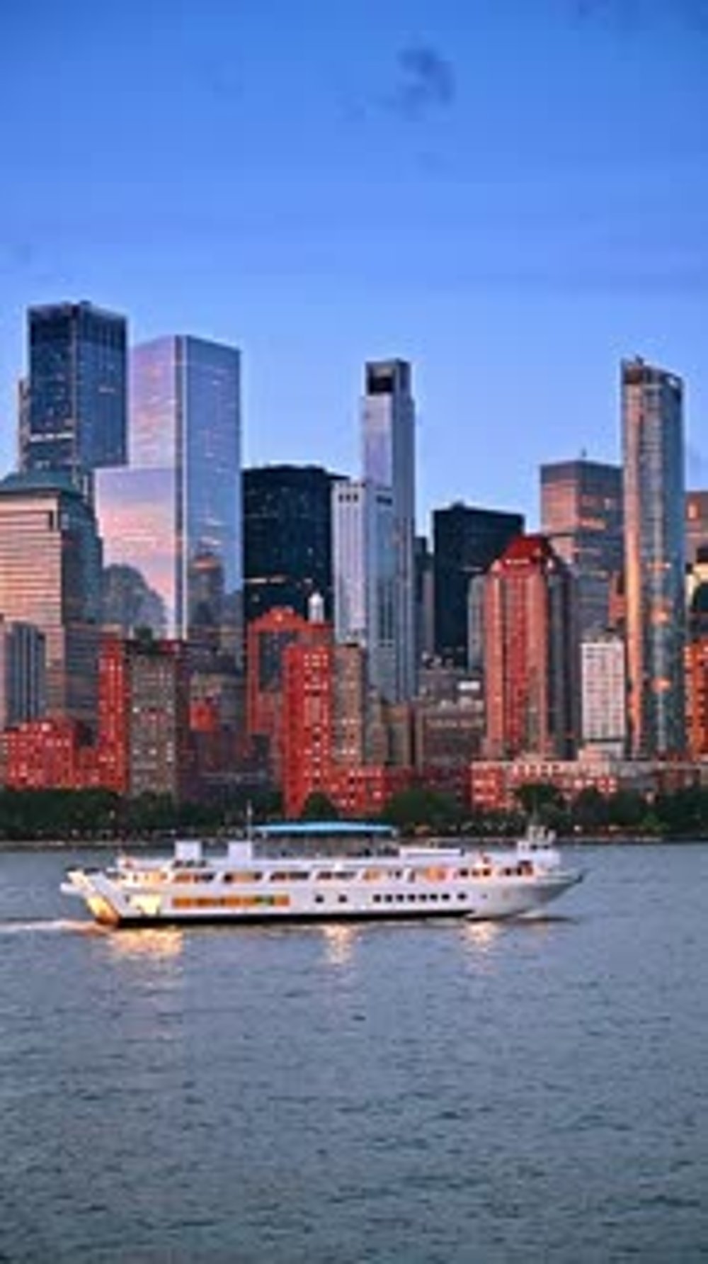 Modern white riverboat travels along the skyline of New York, USA ...