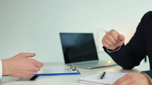 Businessmen Shaking Hands After a Successful Meeting in the Office