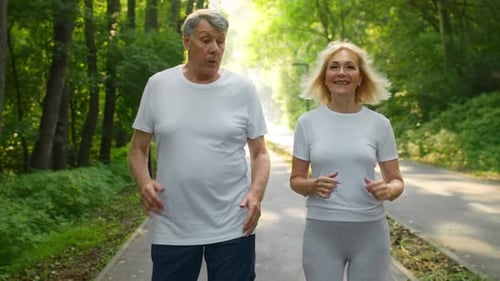 Senior Couple Jogging Together in a Park for an Active Lifestyle