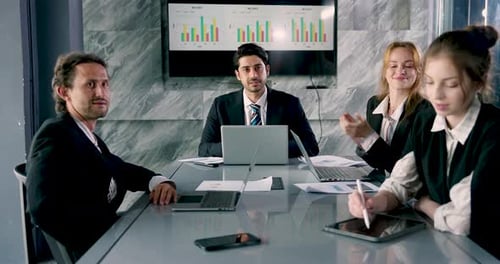 Business Team Applauds Success in Board Room
