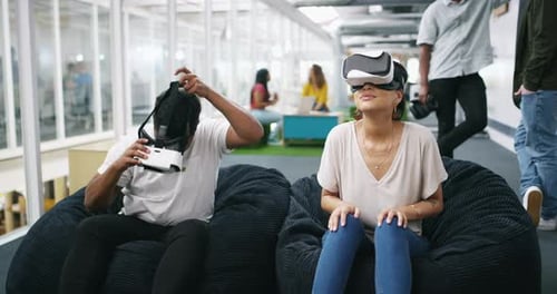 Employees Using Virtual Reality Headsets in Modern Office