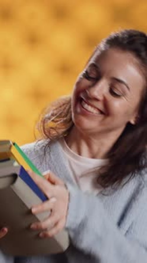 Woman Holds Books and Smiles