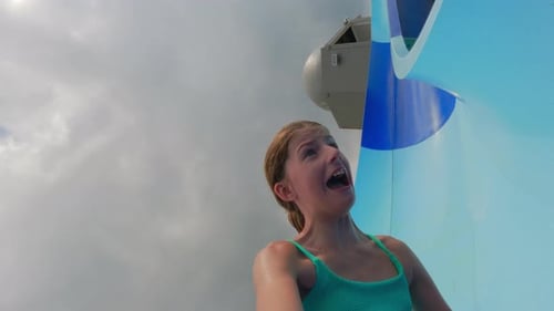 Girl having fun on water slide, summer day