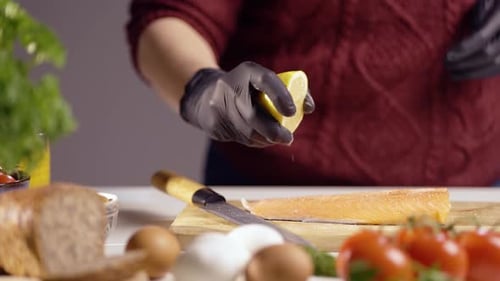 Person Squeezing Lemon on Salmon Fillet