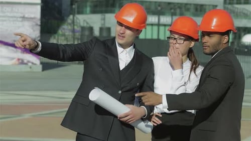 Architects Plan Construction Project Wearing Hard Hats
