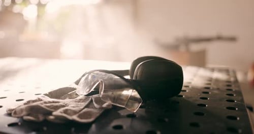 Goggles, gloves and safety for construction in closeup for building, workshop and industry