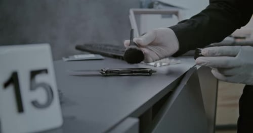 Close Up of Forensic Scientist Finding Fingerprints on Murder Weapon Knife with Brush