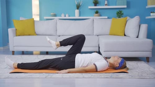 Woman Exercising on Yoga Mat in Bright Home