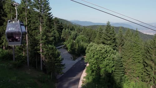 Sarajevo cable car gondola moving above forest toward Trebevic mountain