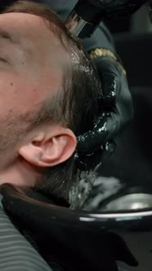 Man Gets Hair Washed at Hair Salon