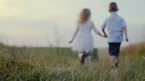 Slow Motion Trim Happy Children Running on Field Road Holding Hands