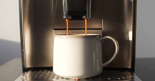 Fresh Coffee Pours into Mug from Coffee Machine